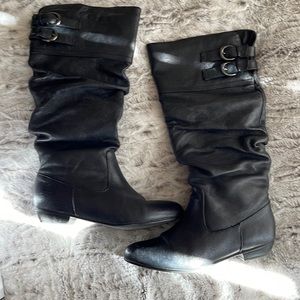 Steve Madden black flat boots.